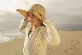 Girl wearing hat at beach. Date : 2008