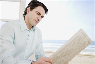 Man reading newspaper. Date : 2008
