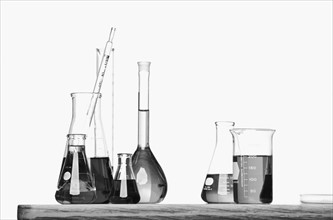 Science beakers with liquid on table. Date : 2008