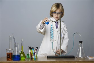 Boy performing science experiment. Date : 2008