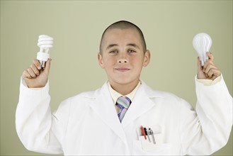 Boy holding light bulbs. Date : 2008