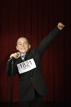Boy wearing number and cheering on stage. Date : 2008