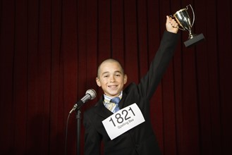 Boy wearing number and holding trophy. Date : 2008