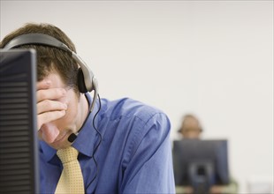 Disappointed businessman wearing headset. Date : 2008