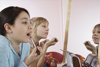 Girls applying lip gloss. Date : 2008