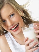 Woman holding glass of milk. Date : 2008