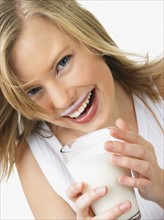 Woman holding glass of milk. Date : 2008