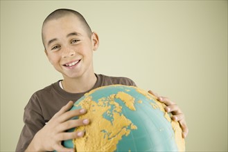 Boy holding globe. Date : 2008