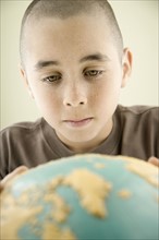 Boy looking at globe. Date : 2008