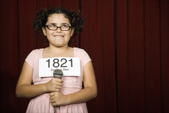 Girl wearing number on stage. Date : 2008