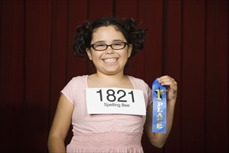 Girl wearing number and holding first place ribbon. Date : 2008
