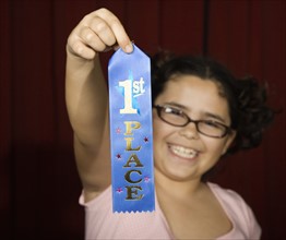 Girl holding first place ribbon on stage. Date : 2008