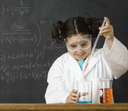 Girl measuring liquid in science class. Date : 2008