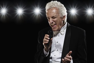 Man in tuxedo singing into microphone. Date : 2008