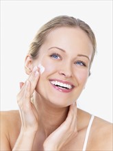 Woman applying face cream. Date : 2008