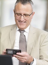Businessman dialing cell phone. Date : 2008