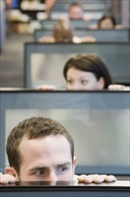 Businesspeople peeking over cubicle walls. Date : 2008