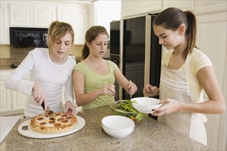 Teenaged girls serving food. Date : 2008