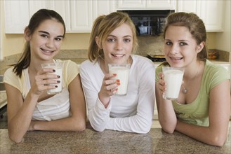 Teenaged girls drinking milk. Date : 2008
