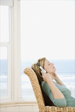 Woman listening to headphones. Date : 2008