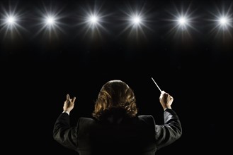 Man conducting under lights. Date : 2008