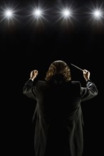 Man conducting under lights. Date : 2008