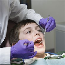 Boy being examined by dentist. Date : 2008