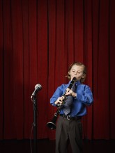 Boy playing clarinet on stage. Date : 2008