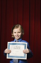 Boy holding certificate on stage. Date : 2008