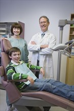 Dentist and dental hygienist with patient. Date : 2008