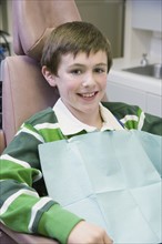 Boy sitting in dentist’s chair. Date : 2008
