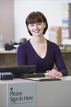 Receptionist sitting at counter. Date : 2008