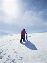 Boy carrying sled in snow. Date : 2008