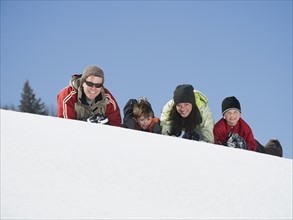 Family laying in snow. Date : 2008