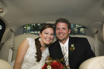 Bride and groom in limousine. Date : 2008