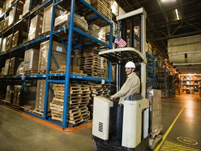 Warehouse worker driving forklift. Date : 2008