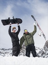 Snowboarders holding snowboards over heads. Date : 2008