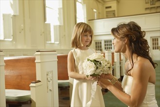 Bride giving bouquet to flower girl. Date : 2008