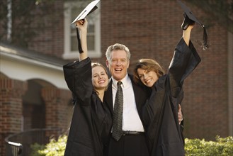 Women graduates with father cheering. Date : 2008