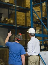 Warehouse workers looking at inventory. Date : 2008