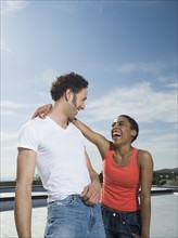 Multi-ethnic couple laughing. Date : 2008