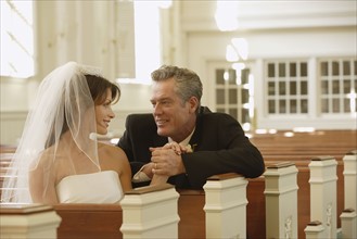Bride and father smiling at each other. Date : 2008