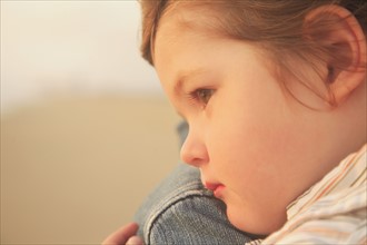 Close up of child resting on parent’s shoulder. Date : 2008