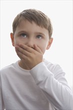 Boy covering mouth with hand. Date : 2008