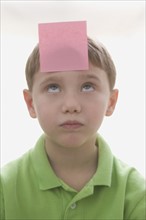 Boy with sticky note on forehead. Date : 2008
