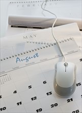 Close up of computer mouse on calendar.