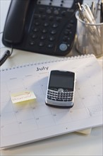 Close up of electronic organizer and calendar.