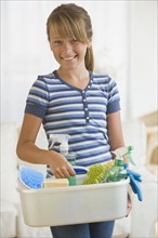 Girl holding bucket of cleaning supplies.