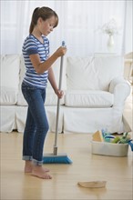 Girl cleaning livingroom.
