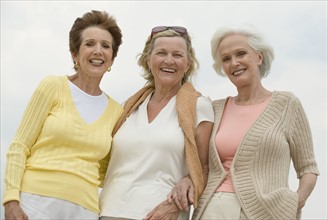 Senior women posing outdoors.